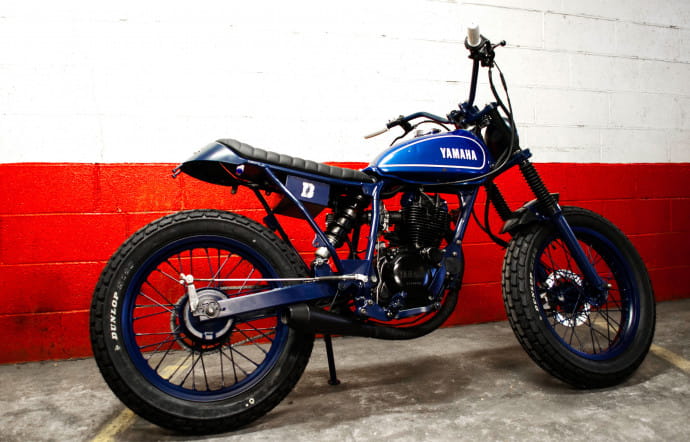 Blitz transforme des motos, souvent des BMW, les déshabille, les peint en noir et les rend méconnaissables en remplaçant le réservoir par celui d’une autre marque. Ici, une Yamaha TW 125.