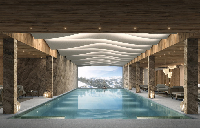 La piscine du Spa Antarès Meribel offre une vue panoramique sur les montagnes enneigées. Crédits : Courtoisie Résidence Antarès Meribel